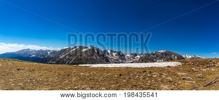 Trail Ridge Road is the name for a stretch of U.S. Highway 34 that traverses Rocky Mountain National Park from Estes Park Colorado in the east to Grand Lake Colorado in the west offering stunning mountain views.