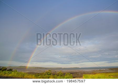 Double rainbow over Lubec Channel during low tide in down east Maine.
