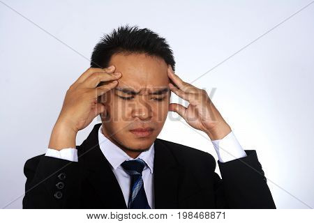 Photo image of young asian businessman headache isolated on white