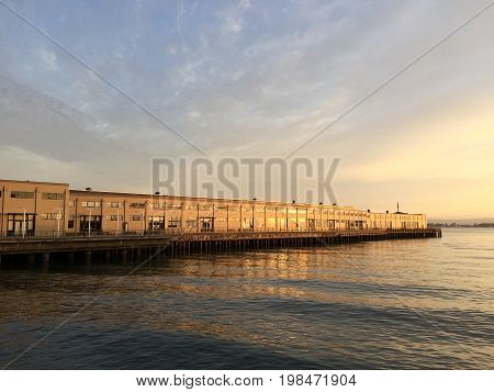 Sunrise reflection on a San Francisco Bay pier