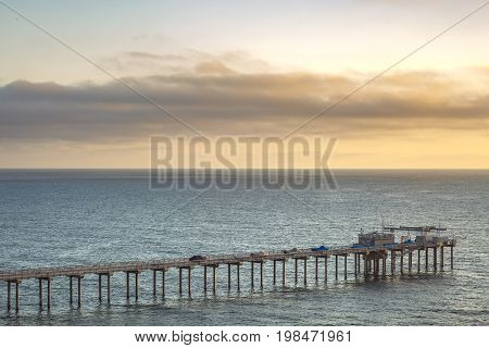 The Scripps Pier And Sunset On The Horizon In California
