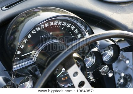 The wheel and speedometer of a classic car