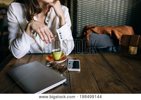 Lunch with successful business lady. Technology background, secretary coffee break, unrecognizable stylish female with bad habits