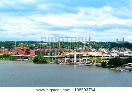 Panoramic photo of the Georgetown waterfront in Washington, D.C. on a cloudy day.