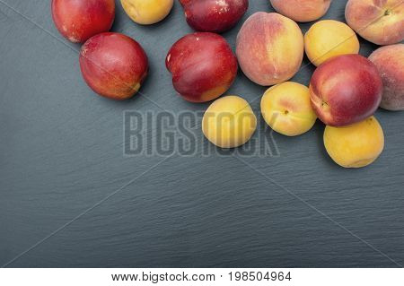 Ripe Apricot And Nectarine On Black Background Of Slate Or Stone