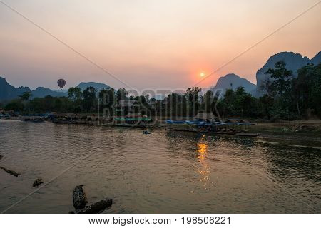 The beautiful sunset over Nam Song River with hot air ballon in Vang Vieng Laos.