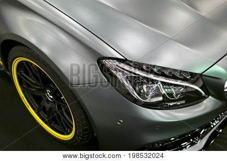 Sankt-Petersburg Russia July 21 2017: Front view of a Mercedes Benz C 63s coupe 2017. Front Headlight. Dark Matt colour .Car exterior details. Photo Taken at Royal Auto Show July 21