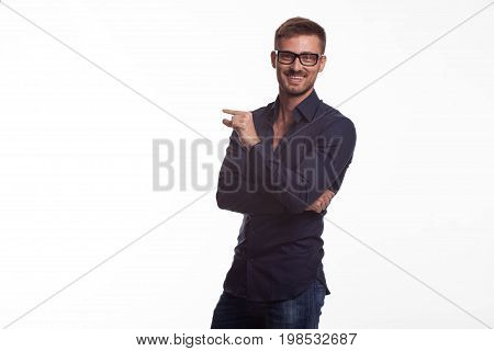 Young jocular man portrait of a confident businessman on a gray background. Ideal for banners, registration forms, presentation, landings, presenting concept.