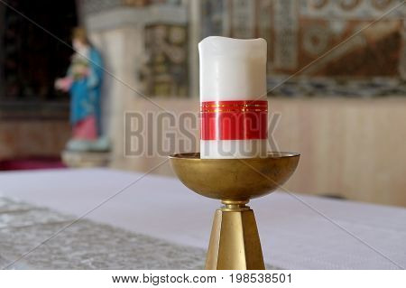 BEIT JAMAL ISRAEL - JULY 22 2017: Candle in the church of St. Stephen the First Martyr and the Virgin Mary in the background