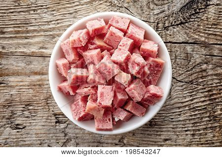 Bowl Of Sliced Ham On Wood; From Above