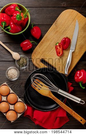 Breakfast. Cooking of an omelette with sweet red bolgarian peppers. Selective focus.