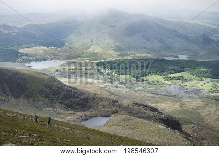 Landscape View Of Llyn Cwellyn And Moel Cynghorion In Snowdonia Shrouded In Fog And Cloud