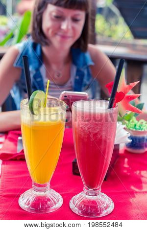 Iced watermelon juice glass on a red table in restaurant and cafe interior. Tropical island of Bali.