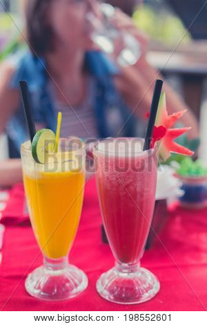 Iced watermelon juice glass on a red table in restaurant and cafe interior. Tropical island of Bali.