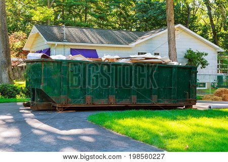 Dumpsters being full with garbage container trash on ecology and environment