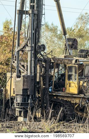 Working mobile pile driving on the basis of a crawler all-terrain vehicle. Workflow of driving reinforced concrete pile with a heavy diesel hammer.
