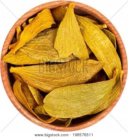 Dried Viscum album in a small wooden bow isolated on white. Macro photo.