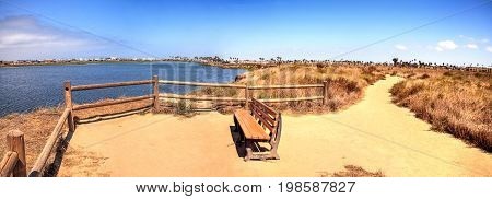 Bench Overlooking The Peaceful And Tranquil Marsh Of Bolsa Chica Wetlands