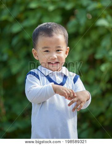asian adorable children toothy smiling face happiness emotion outdoor portrait