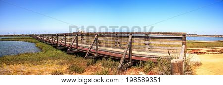 Bridge Along The Peaceful And Tranquil Marsh Of Bolsa Chica Wetlands