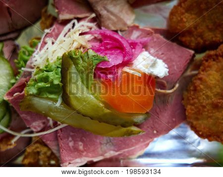 Selection of Smoerrebroed Danish open faced sandwiches on a serving plate