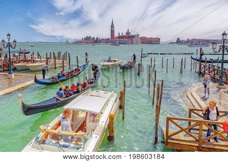 Venice, Italy - May 12, 2017 : Embankment Of The Grand Canal With Gondolas And Gondoliers. Italy.