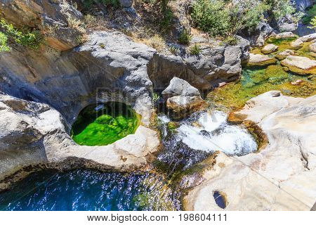 Mountain river with pristine water in Sapadere canyon with stone and natural pool in it