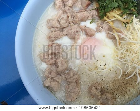 Traditional Thai Porridge Rice Gruel In White Bowl, Congee. In The Street Night Market.