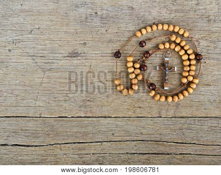 Rosary beads on the old wooden table