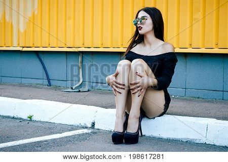 Gorgeous Brunette Girl With A Beautiful Make-up In Fashionable Clothes: A Black Blouse And Shorts Wi