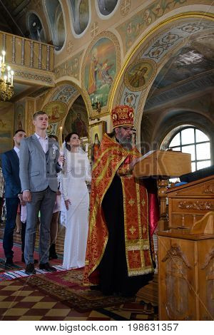 Alchevsk, Ukraine - April 28, 2017: Wedding Ceremony For Newlyweds In The Church