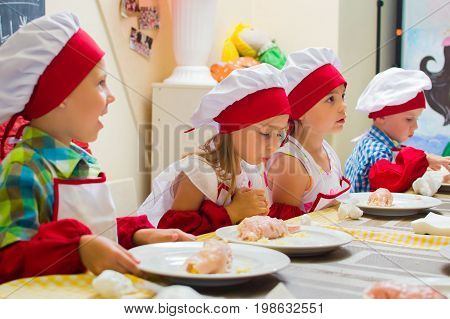Alchevsk, Ukraine - July 23, 2017: School Cook For Children. Meat Rolls With Cheese Are Prepared.