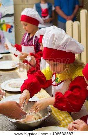 Alchevsk, Ukraine - July 23, 2017: School Cook For Children. Meat Rolls With Cheese Are Prepared.