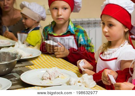 Alchevsk, Ukraine - July 23, 2017: School Cook For Children. Meat Rolls With Cheese Are Prepared.