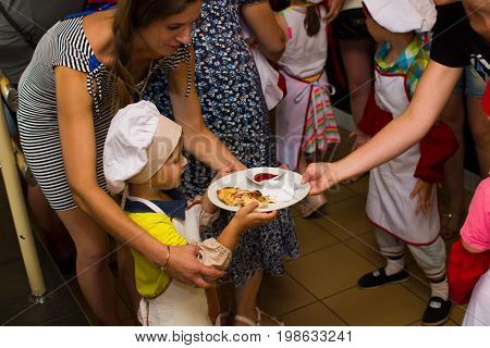 Alchevsk, Ukraine - July 23, 2017: School Cook For Children. Meat Rolls With Cheese Are Prepared.