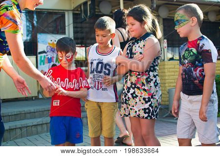 Alchevsk, Ukraine - July 27, 2017: Happy Children Play With Animators In Summer