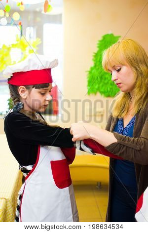 Alchevsk, Ukraine - July 30, 2017: School Cooks For Children. Learn To Cook Pasta With Sausages