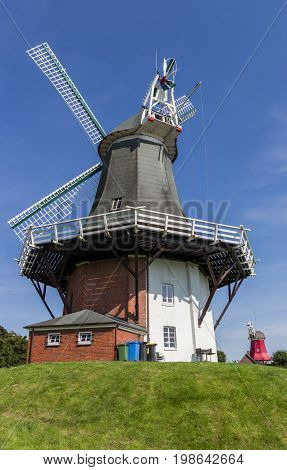 Windmills in the historic center of Greetsiel Germany