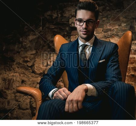 Sharp dressed dandy in a chair