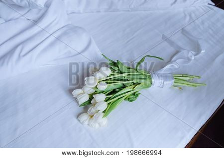 Bouquet Of Tulips On White Bed
