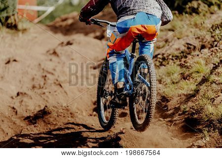 downhill xtreme rider man bike on mountain trail