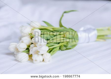 Bouquet Of Tulips On White Bed