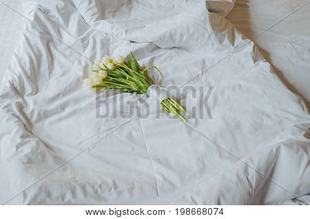 Bouquet Of Tulips On White Bed