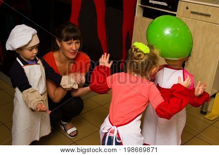Alchevsk, Ukraine - July 30, 2017: School Cooks For Children. Learn To Cook Pasta With Sausages