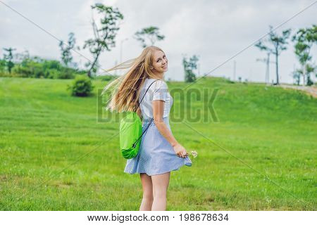 Young Woman Standing With Folded Inflatable Sofa In The Park. Lamzac