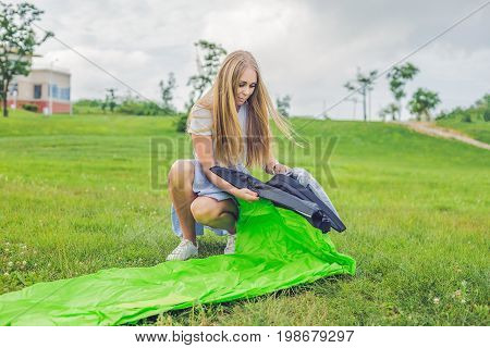 A Woman Tries To Inflate An Air Sofa