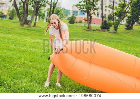 A Woman Tries To Inflate An Air Sofa