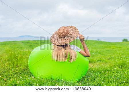 Young Woman Resting On An Air Sofa In The Park.