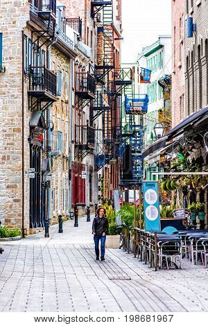 Montreal Canada - May 28 2017: Old town area with person walking in cobblestone alley during summer day in Quebec region city