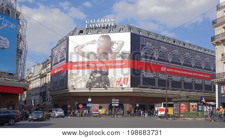 ParisFrance- April 29 2017: La Fayette shopping center view from the Boulevard Haussmann.On the street pedestrians and moving vehicles